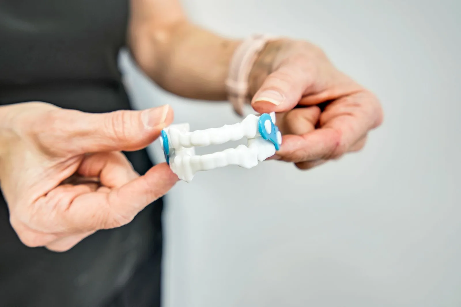 A dental team member holding a custom oral sleep appliance